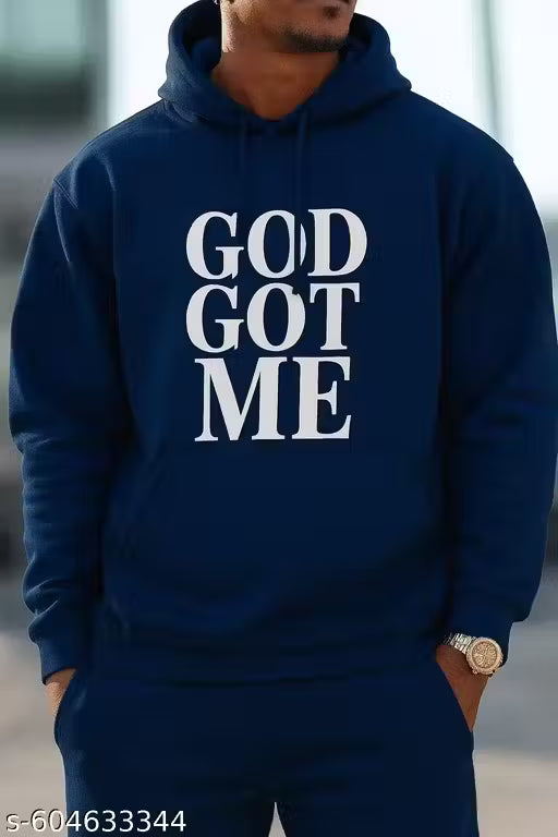 Person wearing a navy blue hoodie with 'GOD GOT ME' text on a blurred background