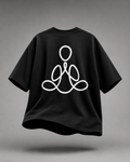 A black short-sleeve t-shirt with a white minimalist line-art graphic of a meditating figure on the front, shown floating against a neutral gray background.