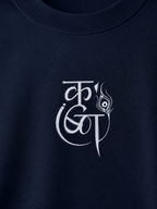 Close-up of a navy blue crewneck sweatshirt featuring a white stylized graphic print on the chest.