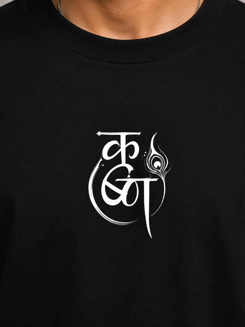Close-up of minimalist Krishna-inspired chest print on black premium cotton T-shirt