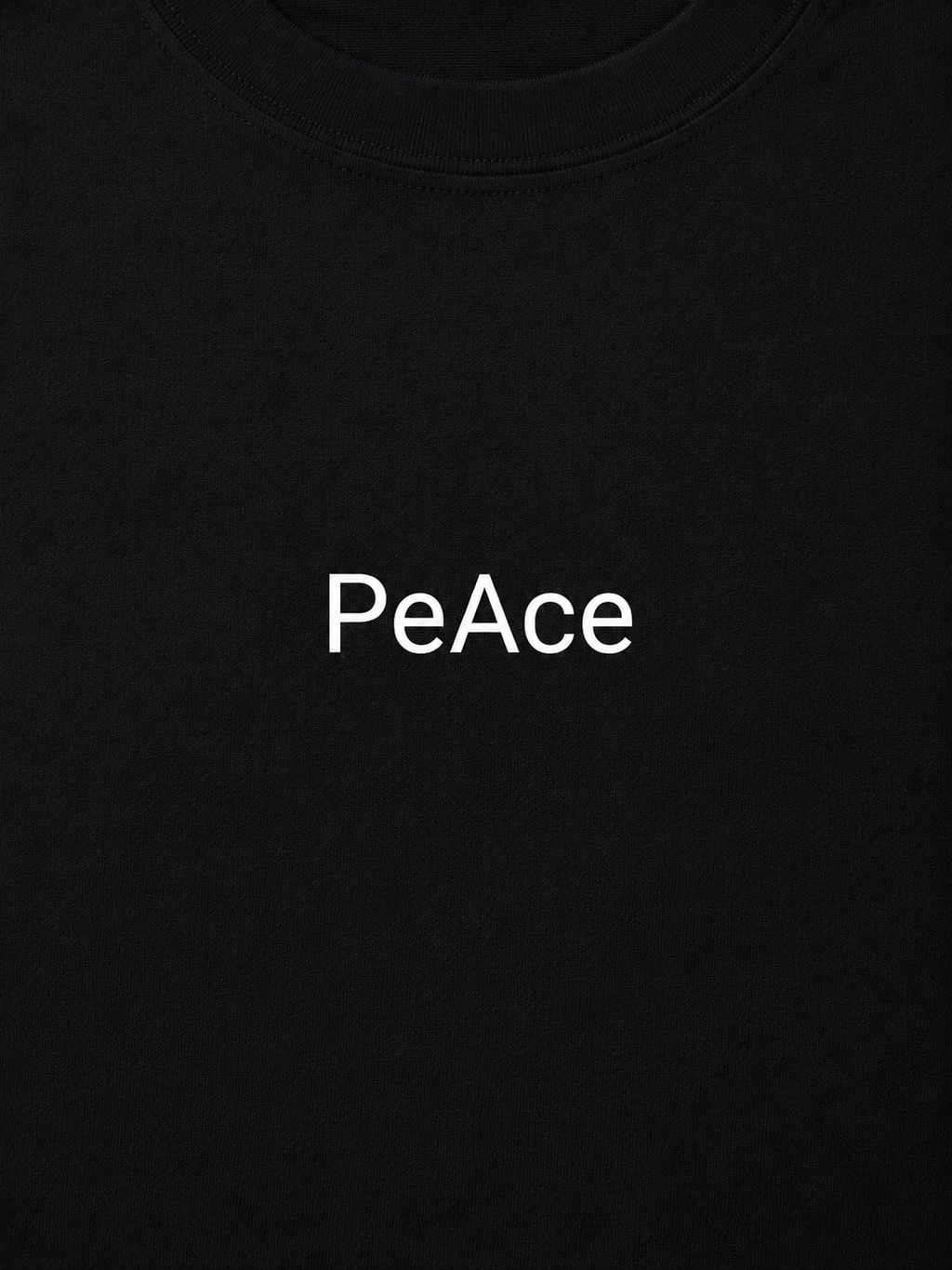 Close-up of a black crewneck t-shirt featuring the word 'PeAce' printed in white sans-serif font across the chest.