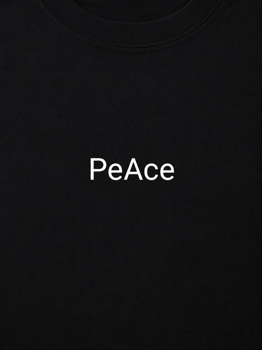 Close-up of a black crewneck t-shirt featuring the word 'PeAce' printed in white sans-serif font across the chest.