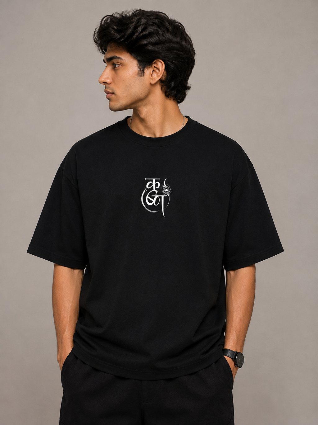 Front view of model wearing black MĀDHAVA Krishna graphic T-shirt with minimal chest design