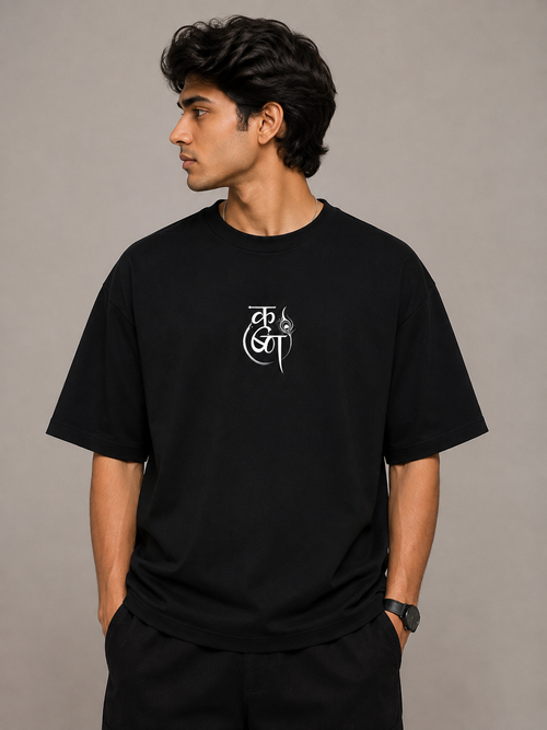 Front view of model wearing black MĀDHAVA Krishna graphic T-shirt with minimal chest design