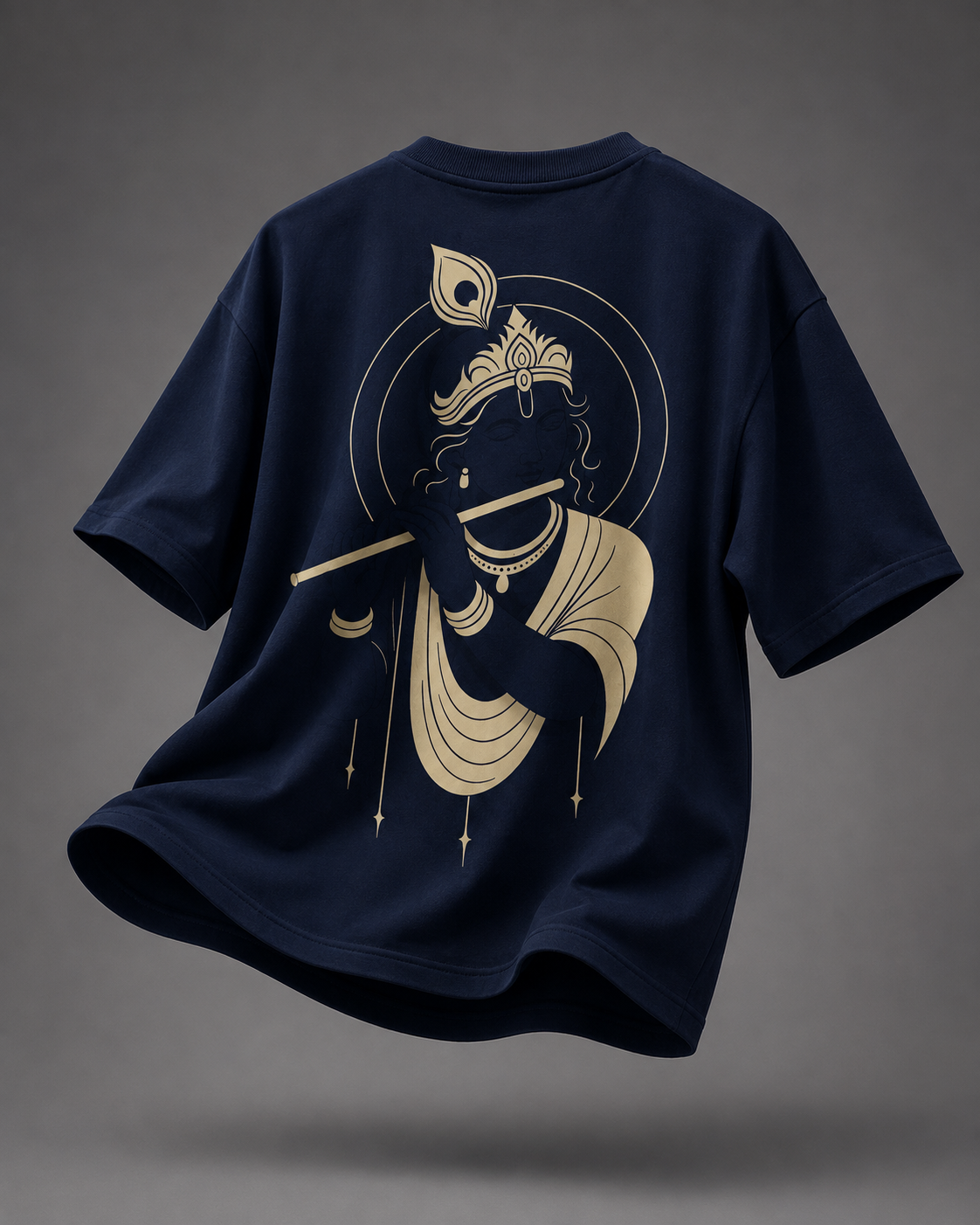 A navy blue short-sleeve t-shirt shown from the back, featuring a large gold graphic of Lord Krishna holding a flute. The t-shirt is presented in a floating, dynamic pose against a dark gray studio background.